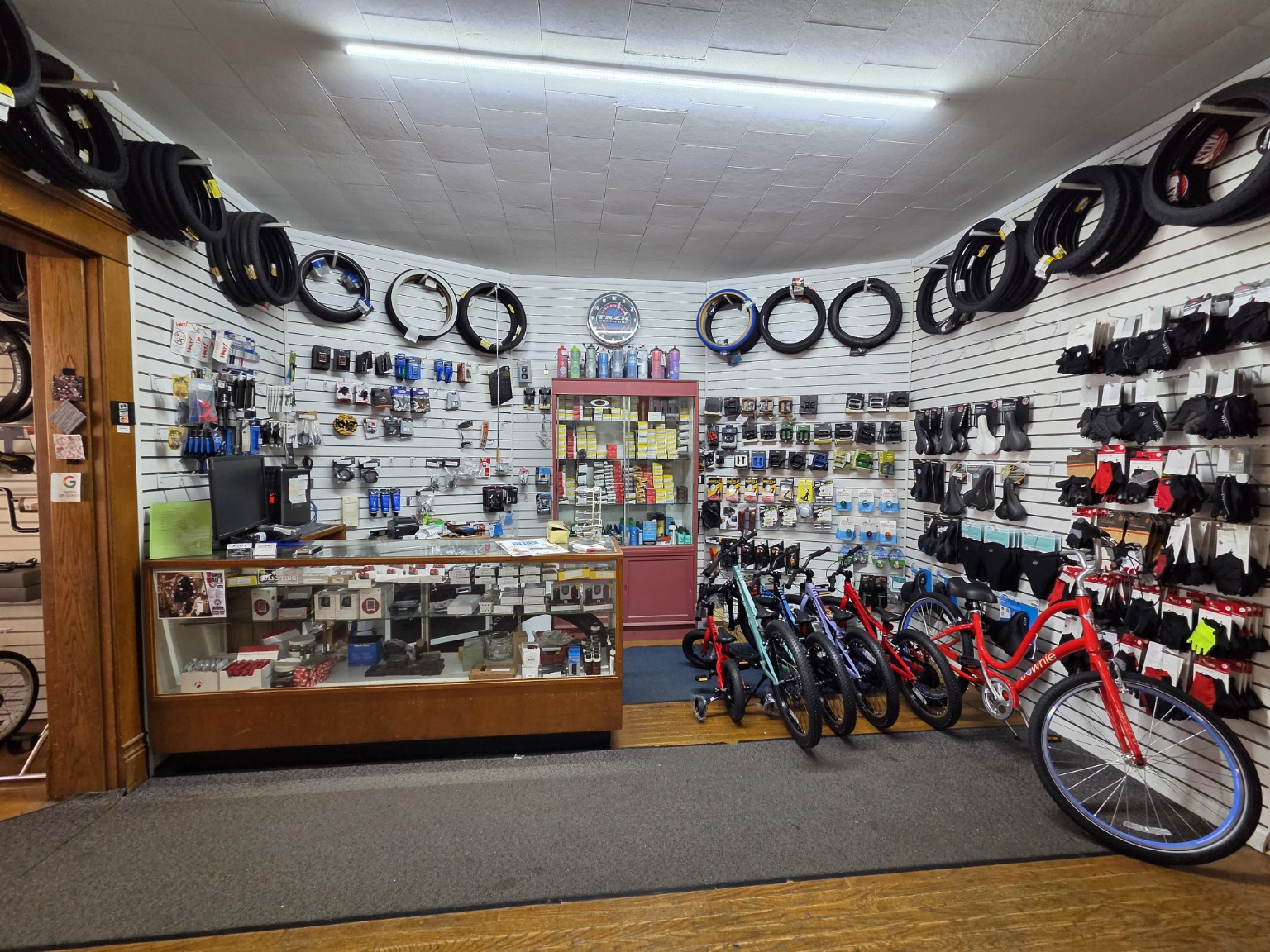 Rocky’s bicycle parts counter with saddles, pedals, gloves and accessories